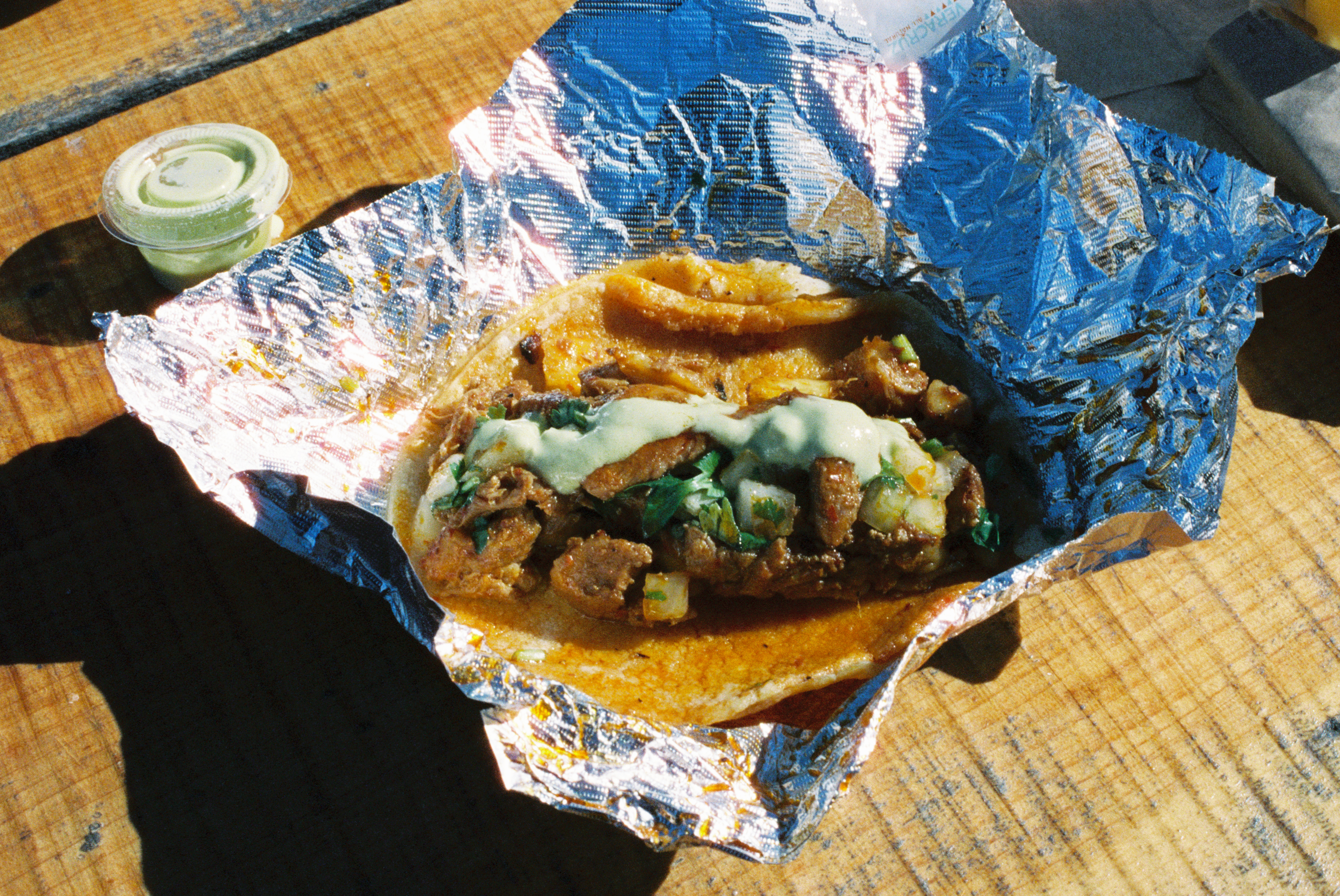 Taco in tin foil in direct sunlight