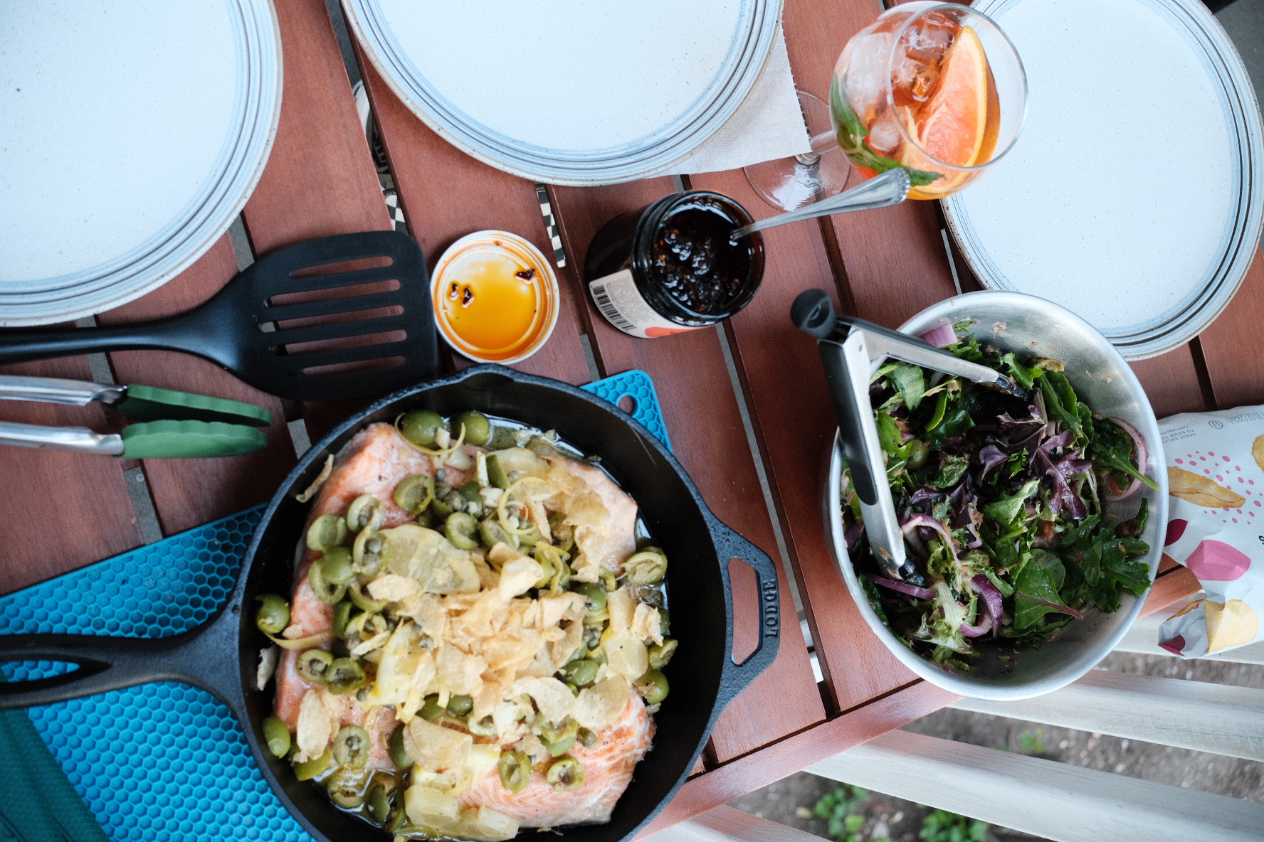 Salmon, salad, and an aperol sprint on an outdoor table
